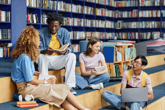Diverse group of students studying together in a library